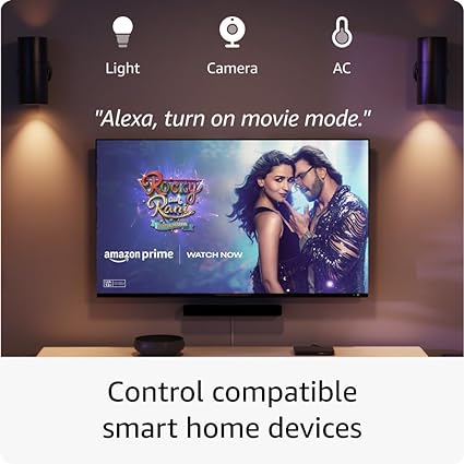 A person tells a smart device, "Alexa, turn on movie mode," in a cozy living room.